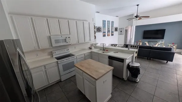 a kitchen with a stove sink and a refrigerator