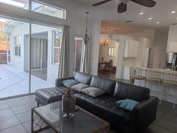 a living room with furniture and a chandelier