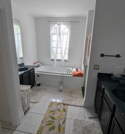 a bathroom with a sink a toilet and a tub