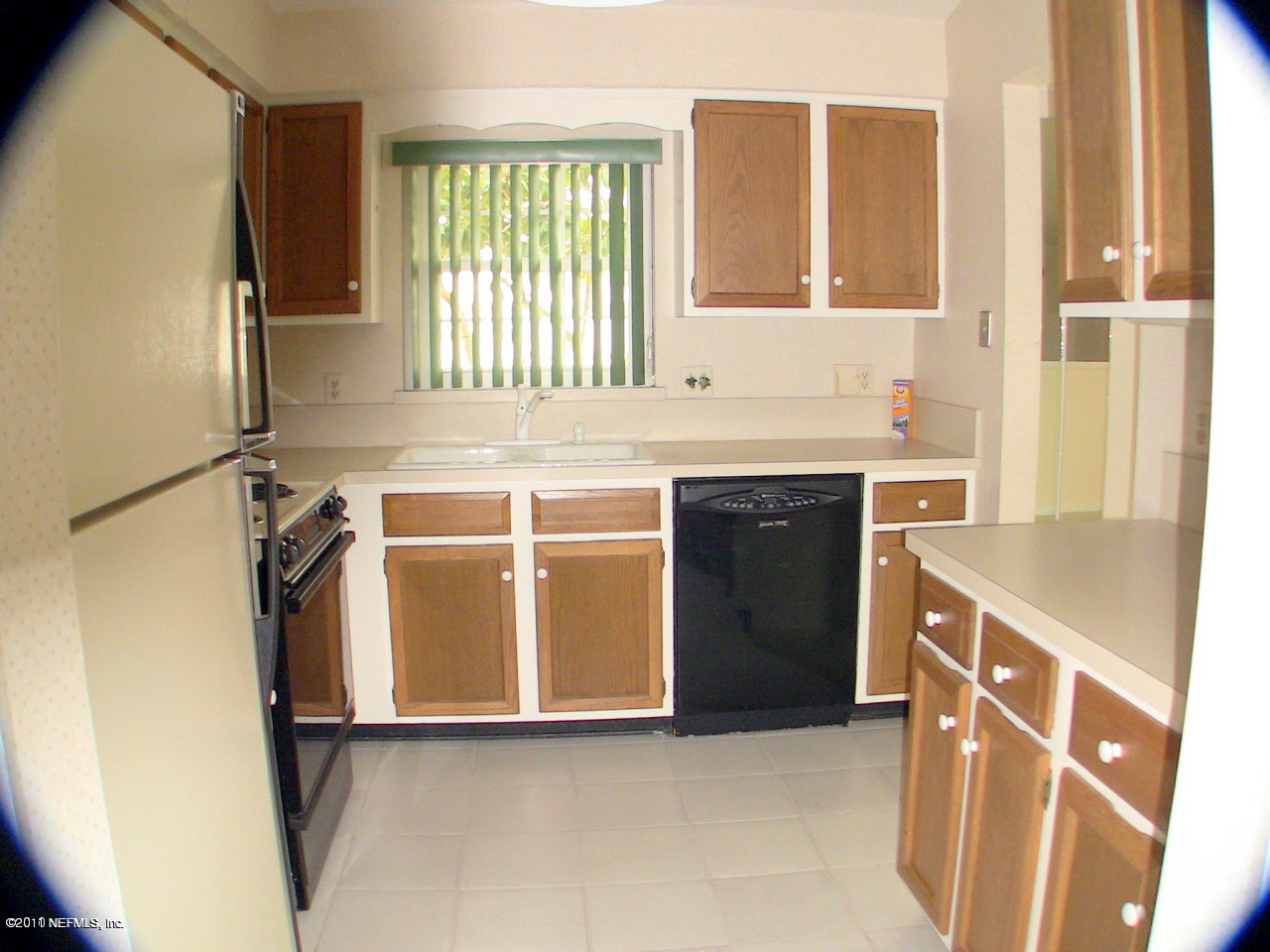 10844 Reading Road Jacksonville, FL 32257 - Photo 6 of 10 a utility room with stainless steel appliances granite countertop a sink and a refrigerator