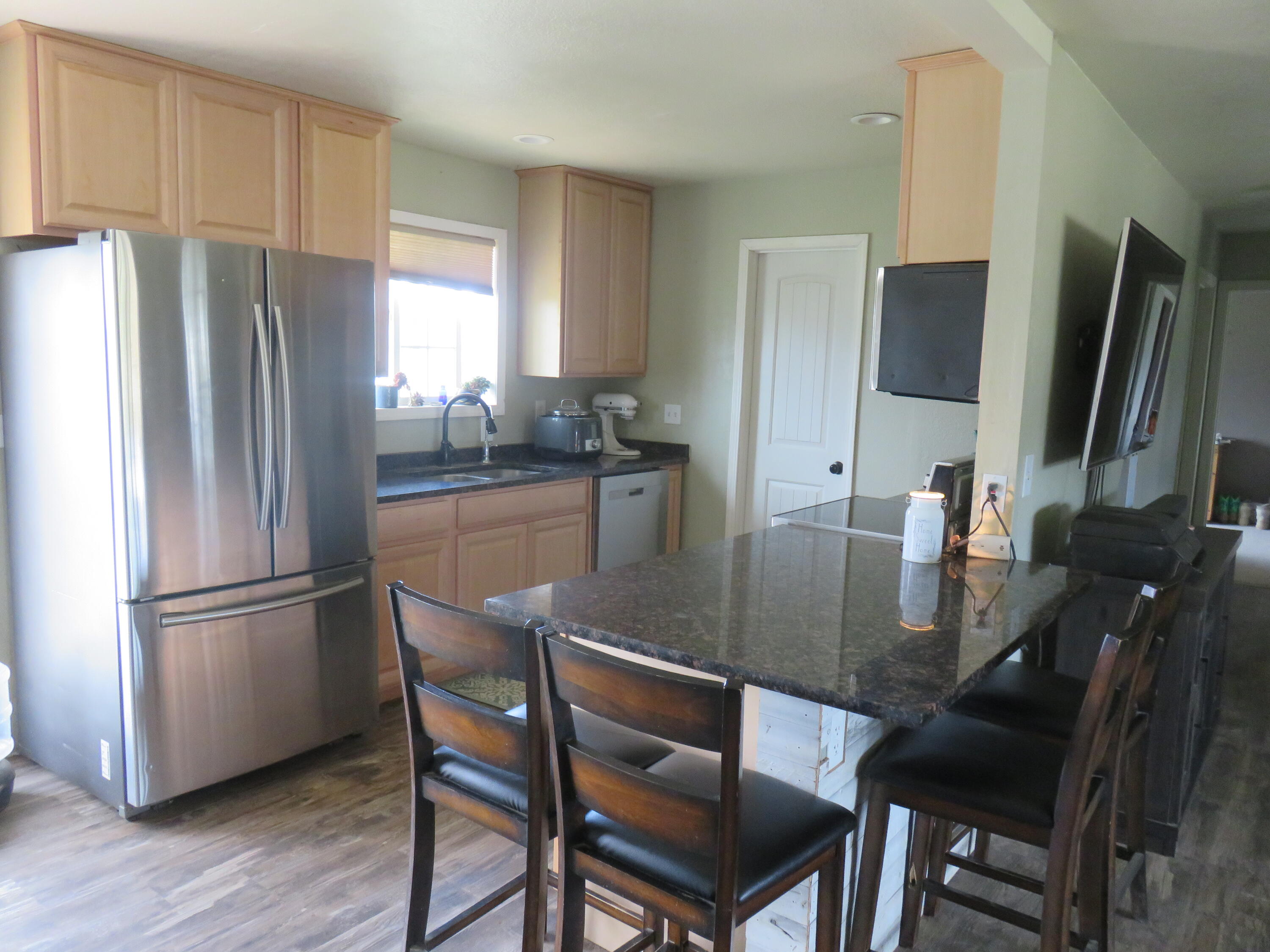 3798 County Road 91 Lookout, CA 96054 - Photo 22 of 54 a kitchen with a dining table and refrigerator