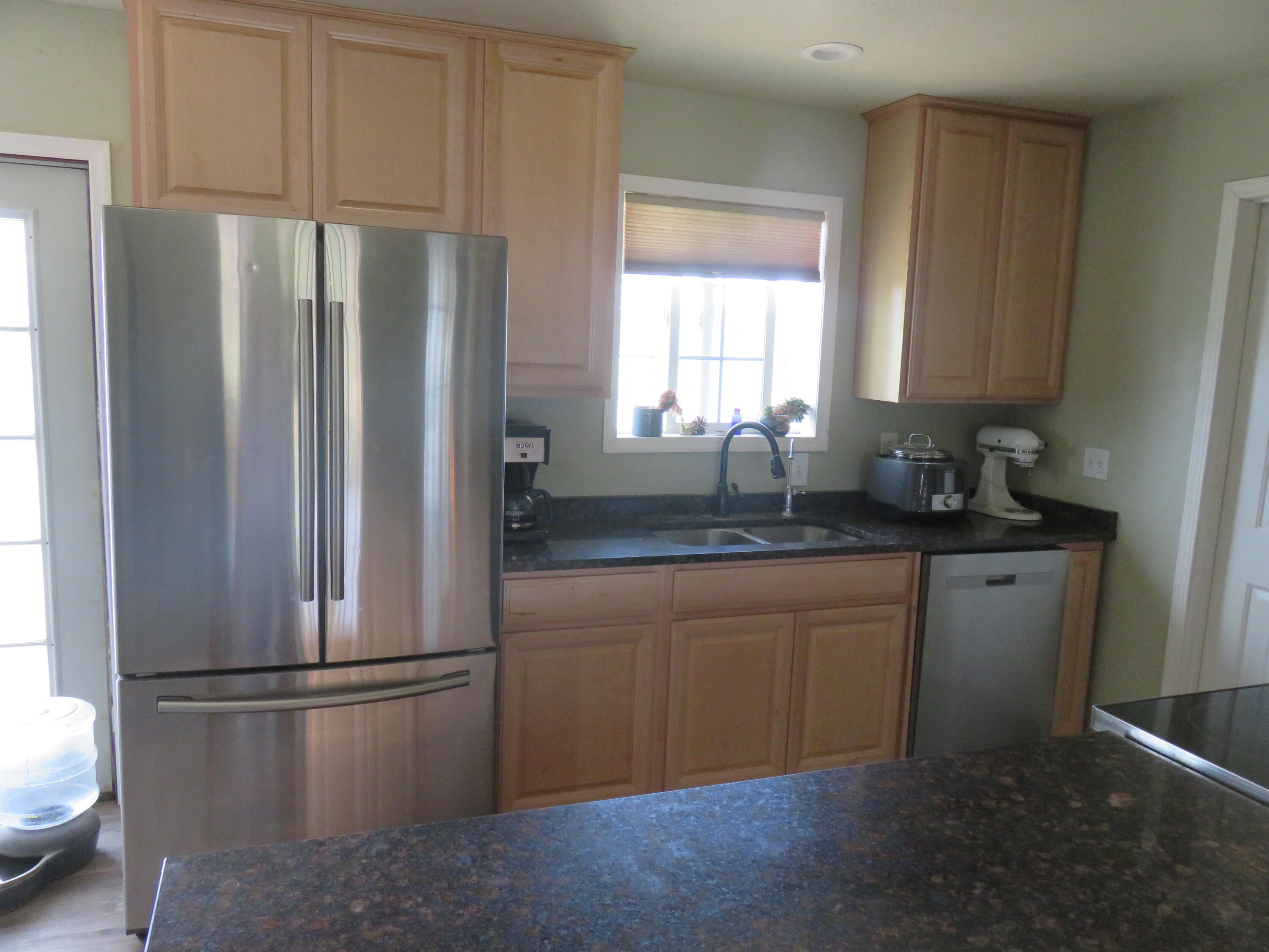 3798 County Road 91 Lookout, CA 96054 - Photo 23 of 54 a kitchen with stainless steel appliances granite countertop a refrigerator sink and white cabinets