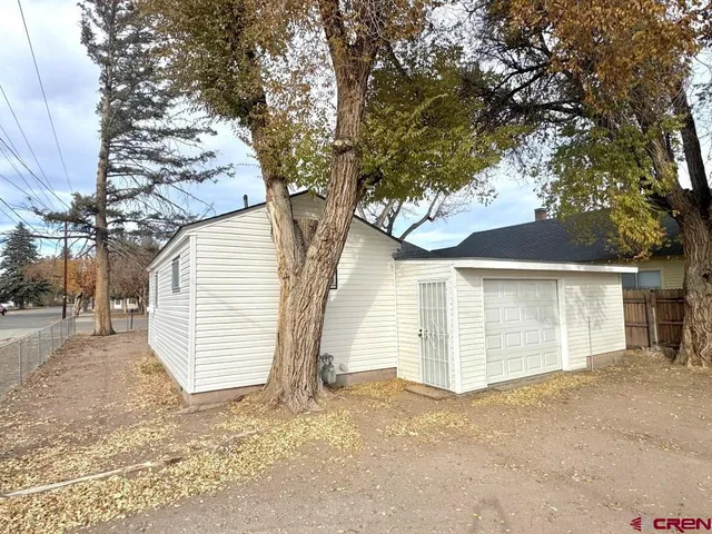 a view of a house with a snow and tree