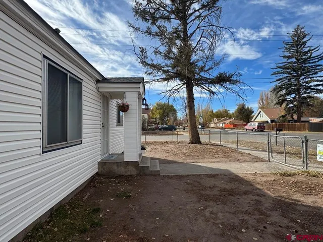 a view of a backyard with large trees