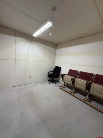 a view of a livingroom with couch and a ceiling fan