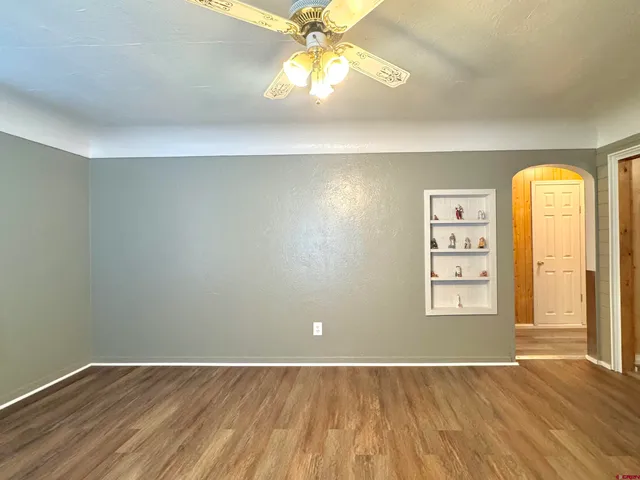 an empty room with windows and closet