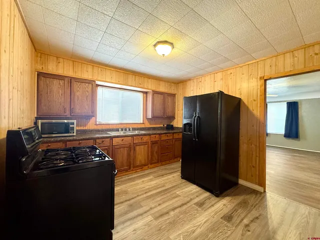 a kitchen with a refrigerator and a stove