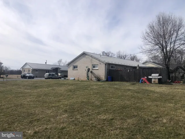 a front view of house with yard and car parked
