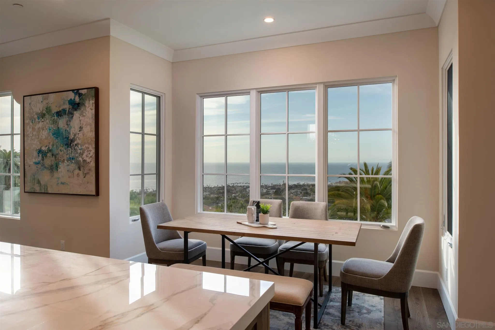 1206 Muirlands Drive La Jolla, CA 92037 - Photo 14 of 75 a view of a dining room with furniture large windows and wooden floor