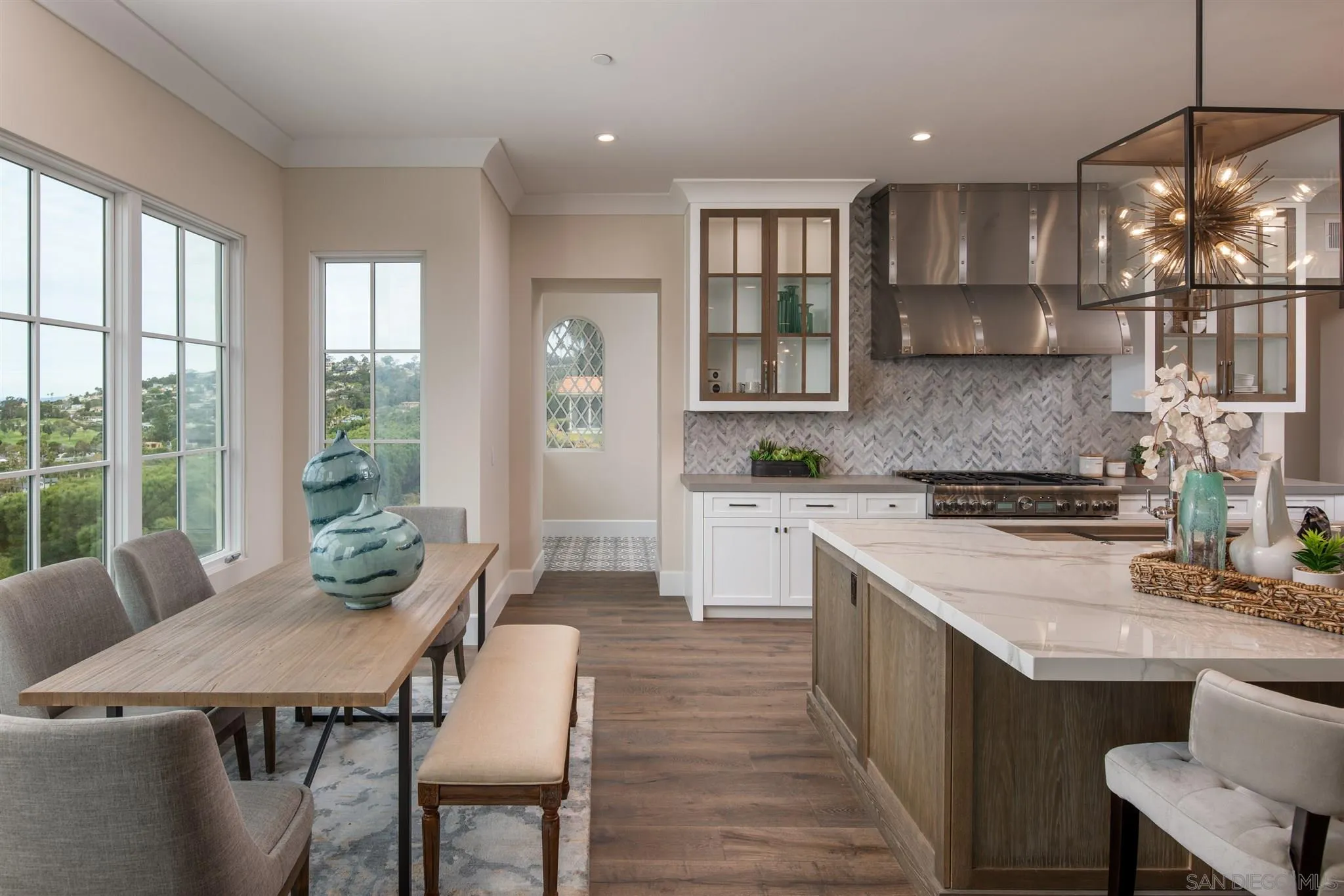 1206 Muirlands Drive La Jolla, CA 92037 - Photo 15 of 75 a kitchen with a table chairs sink and cabinets