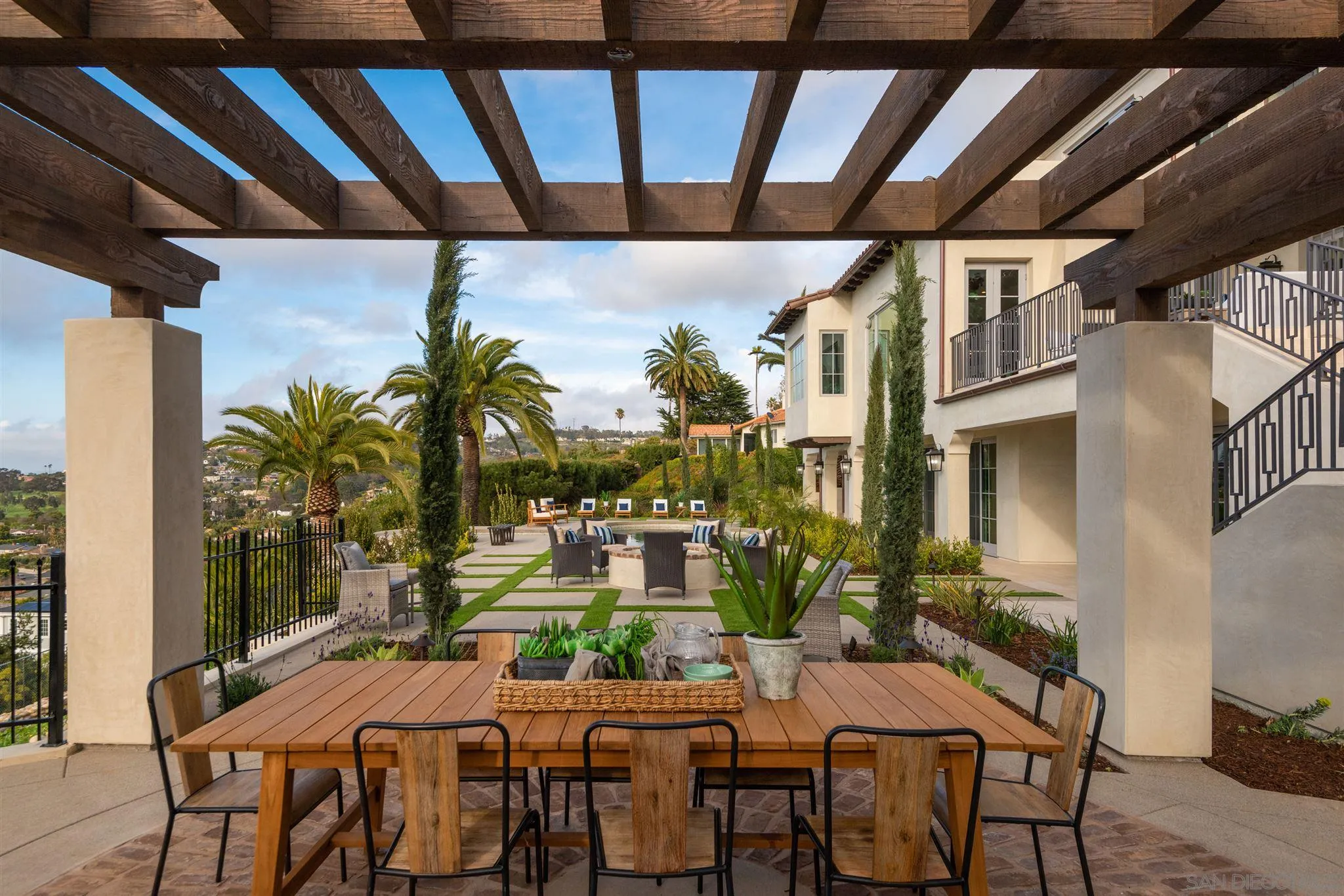 1206 Muirlands Drive La Jolla, CA 92037 - Photo 42 of 75 a view of an outside dining space with a table and chairs