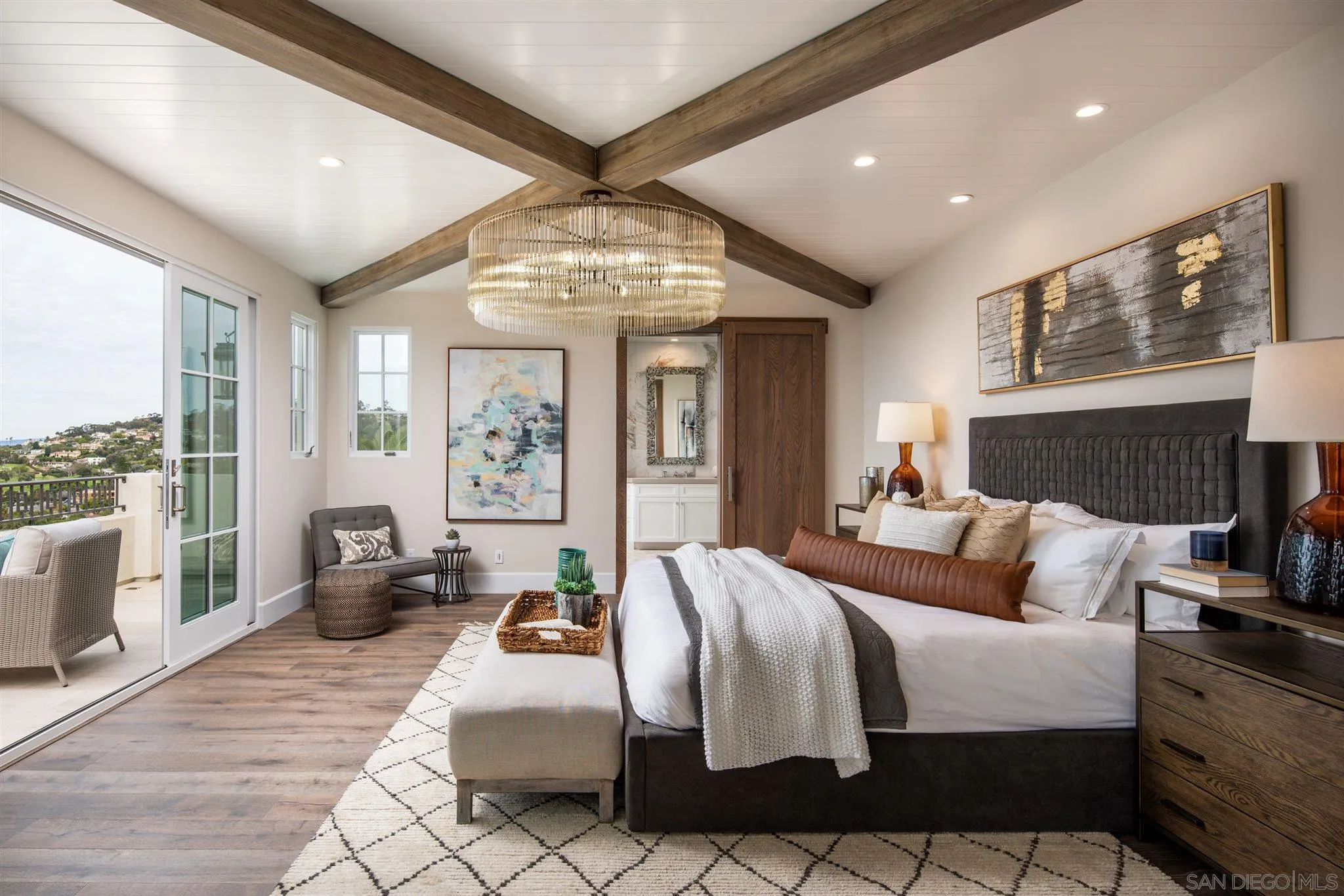 1206 Muirlands Drive La Jolla, CA 92037 - Photo 49 of 75 a bedroom with a large bed and a chandelier