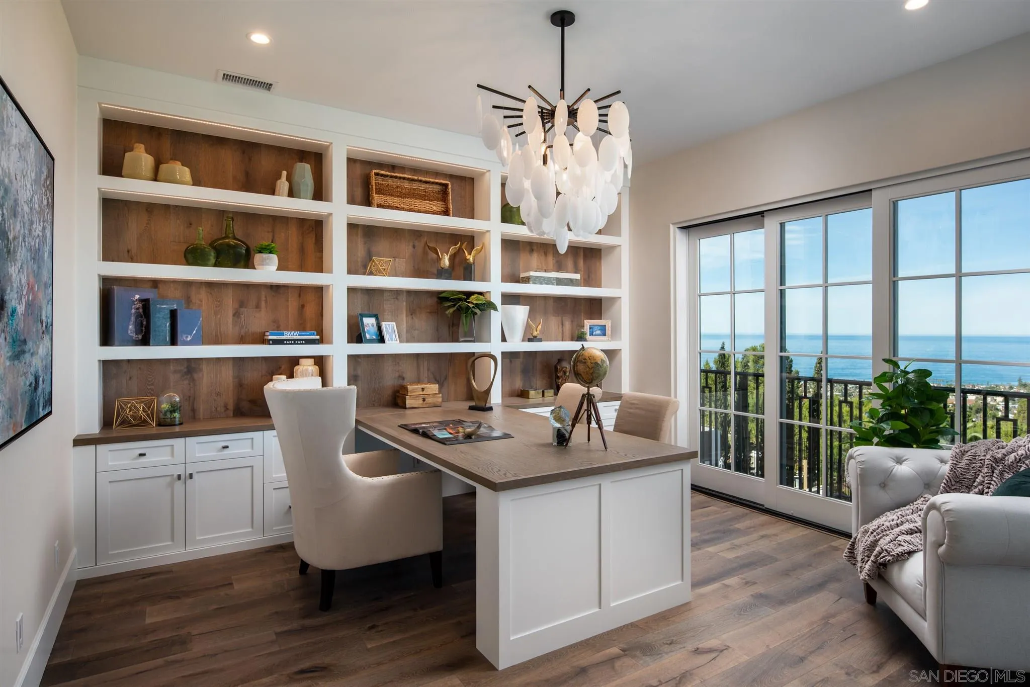 1206 Muirlands Drive La Jolla, CA 92037 - Photo 67 of 75 a work room with furniture wooden floor and a book shelf