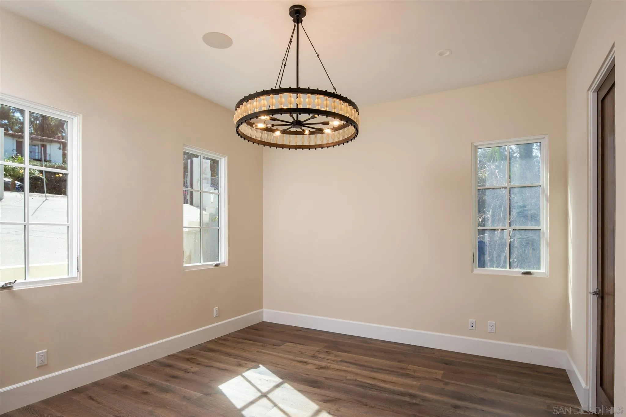 1206 Muirlands Drive La Jolla, CA 92037 - Photo 70 of 75 a view of a room with wooden floor and windows