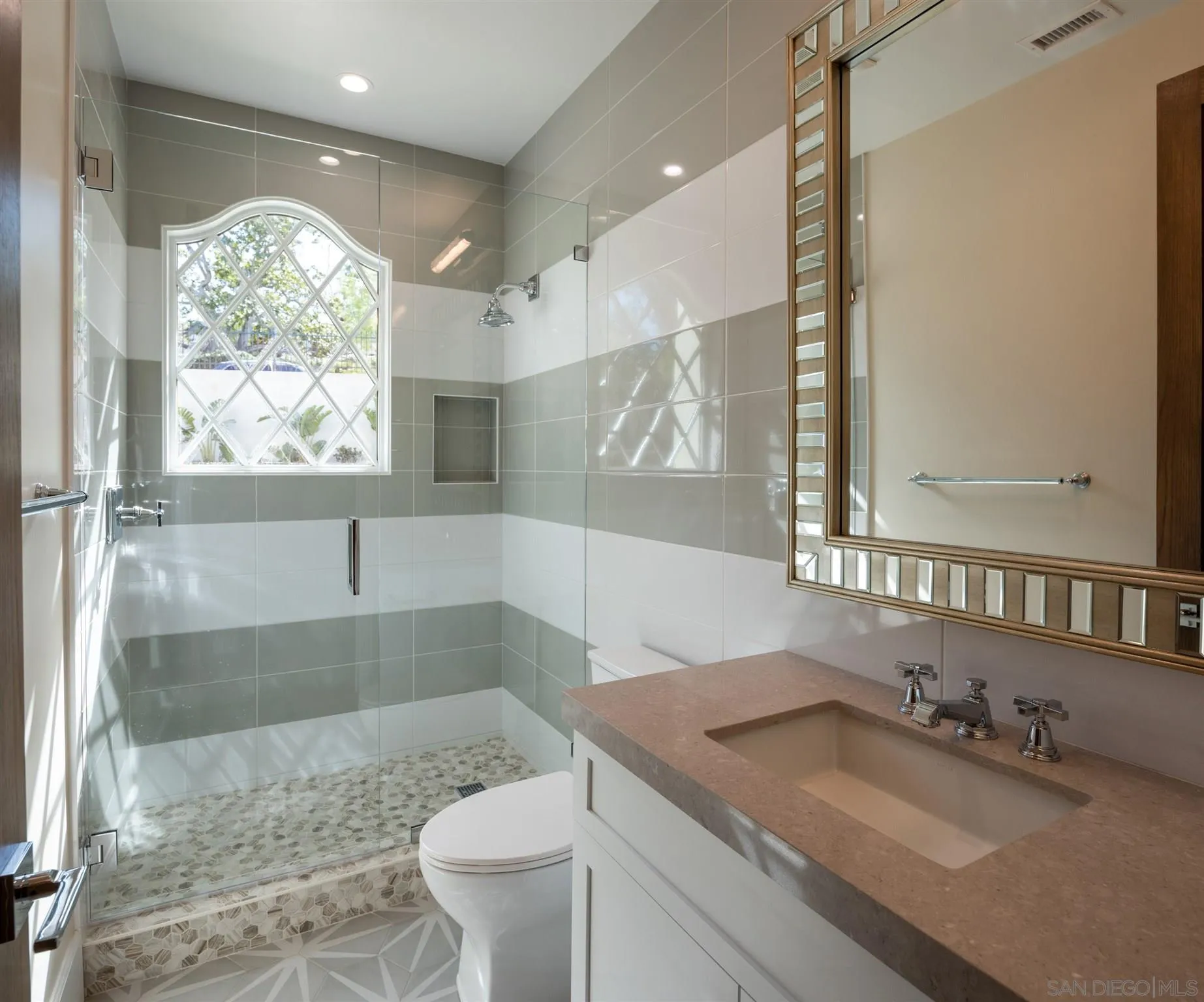 1206 Muirlands Drive La Jolla, CA 92037 - Photo 71 of 75 a bathroom with a granite countertop sink a toilet a mirror and window