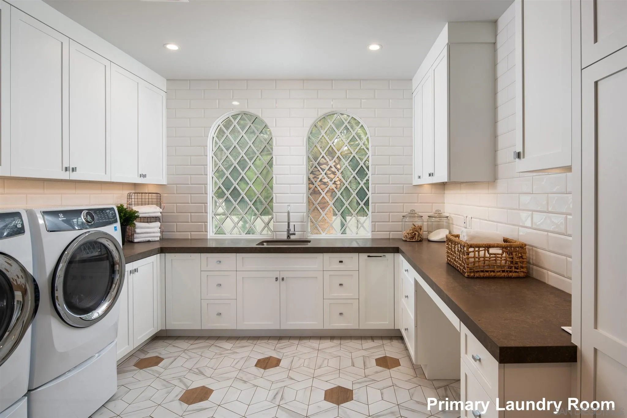 1206 Muirlands Drive La Jolla, CA 92037 - Photo 72 of 75 a kitchen with granite countertop a sink a stove and cabinets