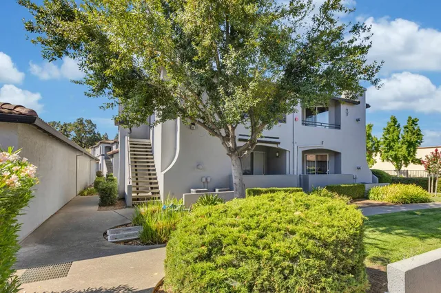a front view of house with yard and green space