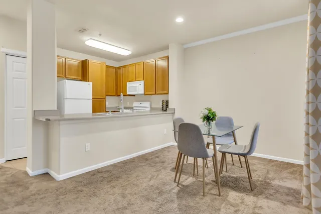 a kitchen with a table and chairs in it