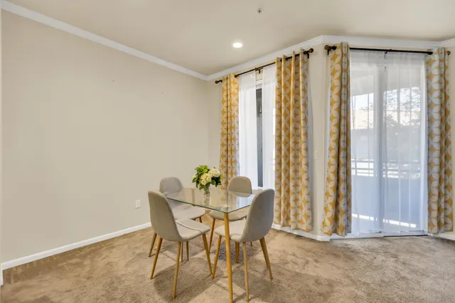 a dining room with furniture and front door