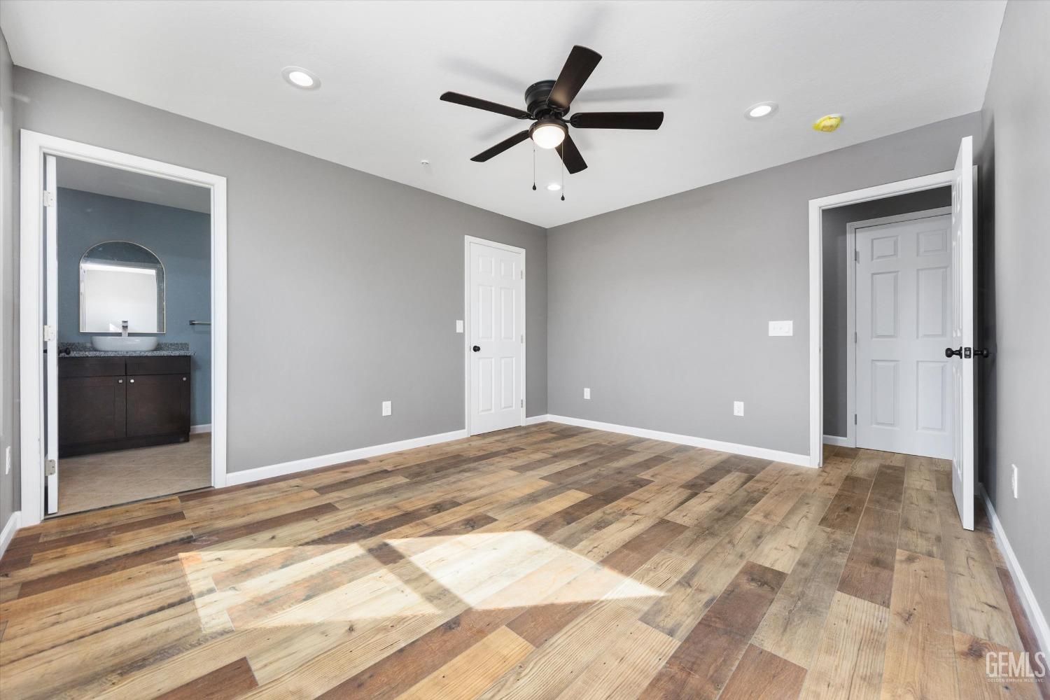 Undisclosed Address Bakersfield, CA 93307 - Photo 18 of 22 a view of a livingroom with a ceiling fan and wooden floor