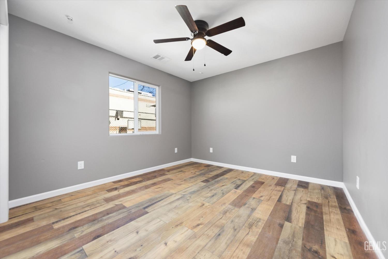 Undisclosed Address Bakersfield, CA 93307 - Photo 20 of 22 wooden floor in an empty room with a window