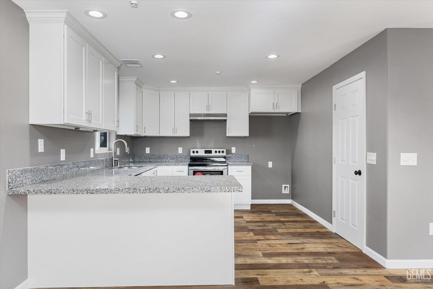 Undisclosed Address Bakersfield, CA 93307 - Photo 9 of 22 a kitchen with stainless steel appliances granite countertop a sink stove and refrigerator