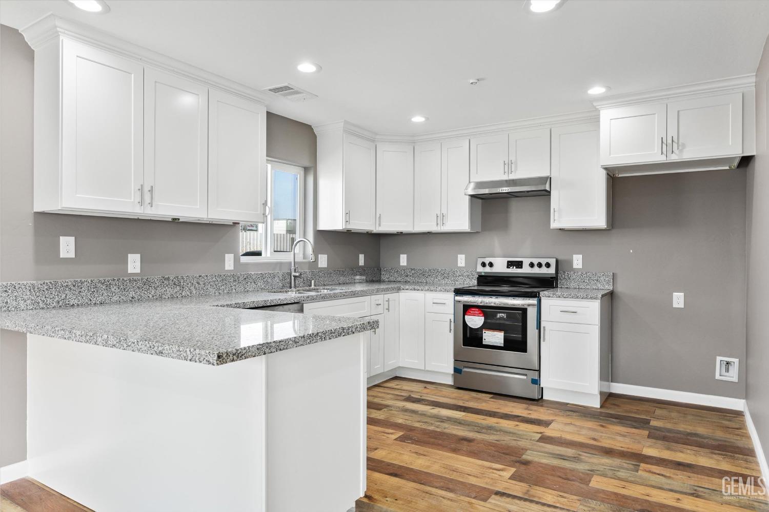 Undisclosed Address Bakersfield, CA 93307 - Photo 10 of 22 a kitchen with stainless steel appliances granite countertop a stove a sink and a granite counter tops