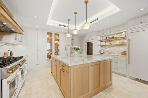 a kitchen with stainless steel appliances granite countertop a sink and a refrigerator