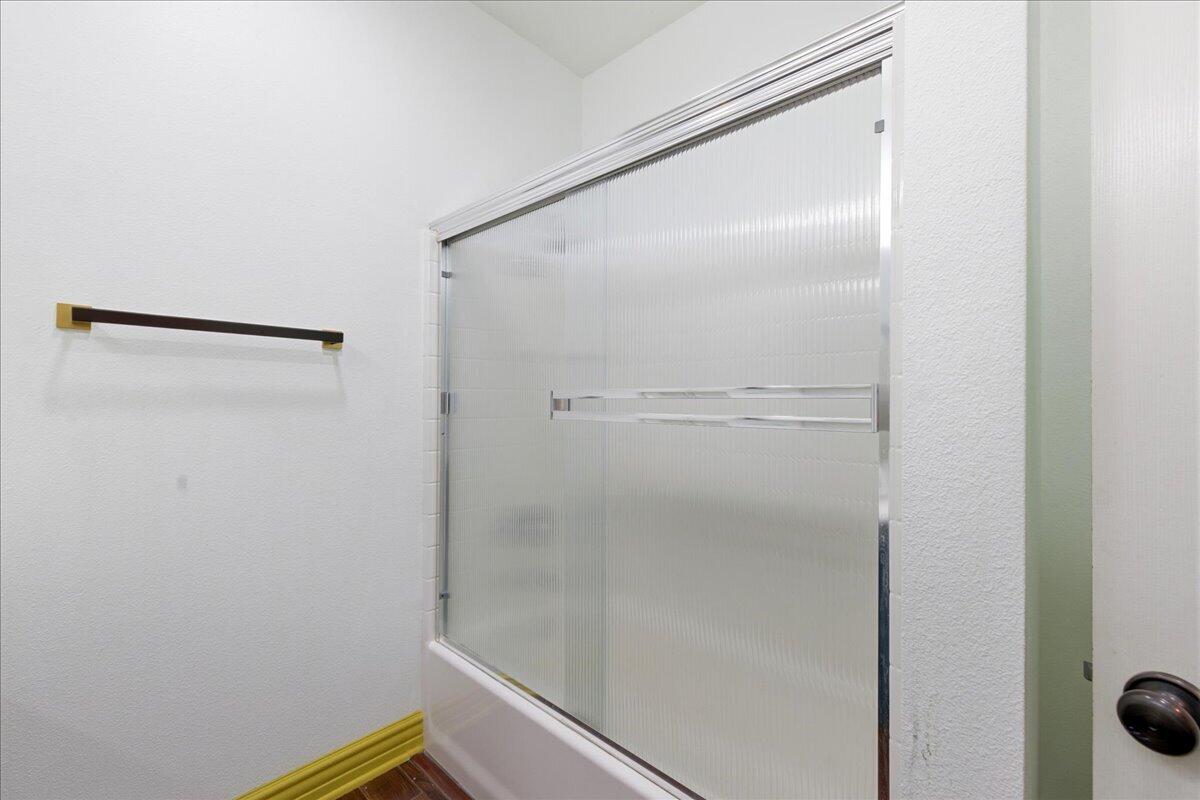 23732 Bella Vista Road Corona, CA 92883 - Photo 30 of 49 a bathroom with a glass shower door