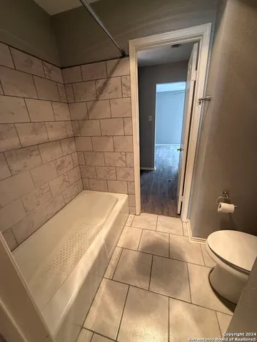 a bathroom with a bathtub and toilet