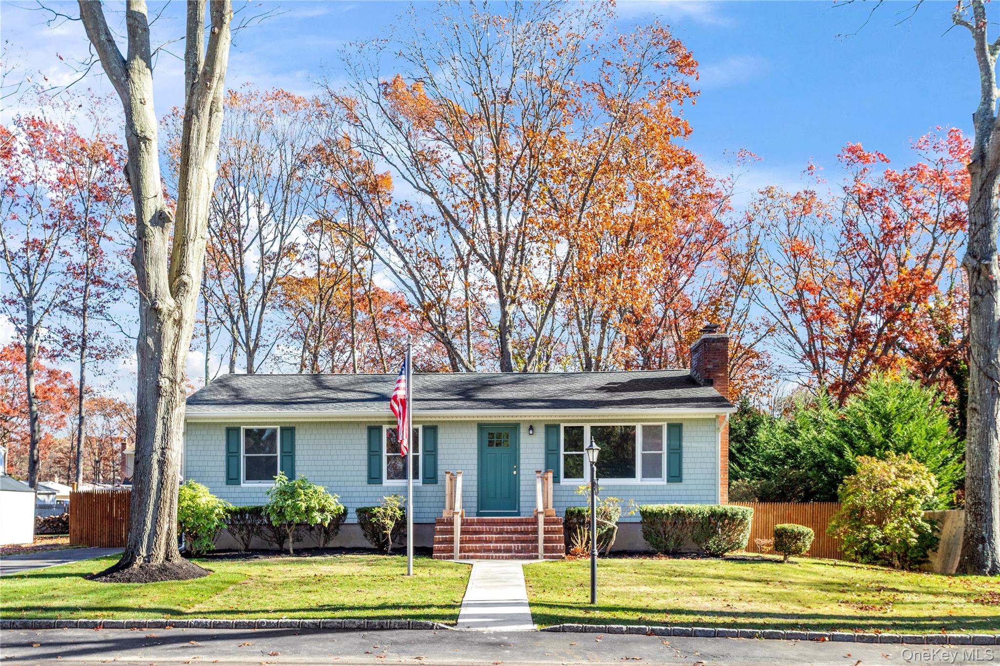 a front view of a house with a garden and plants