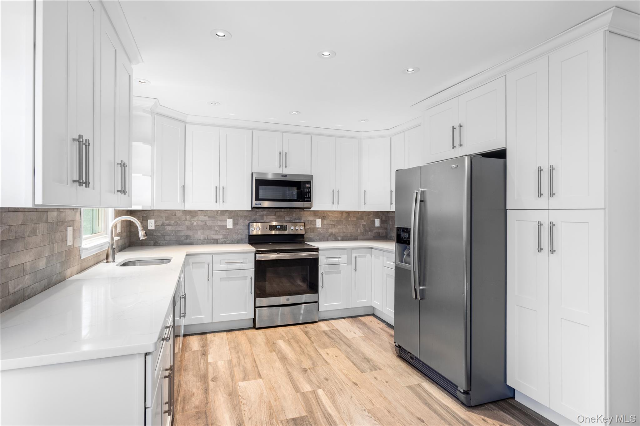 11 Seneca Trail Ridge, NY 11961 - Photo 2 of 10 a kitchen with a refrigerator cabinets and wooden floor