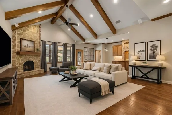 a living room with furniture a fireplace and a table