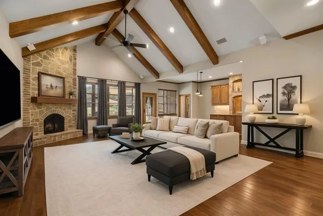 a living room with furniture a fireplace and a table