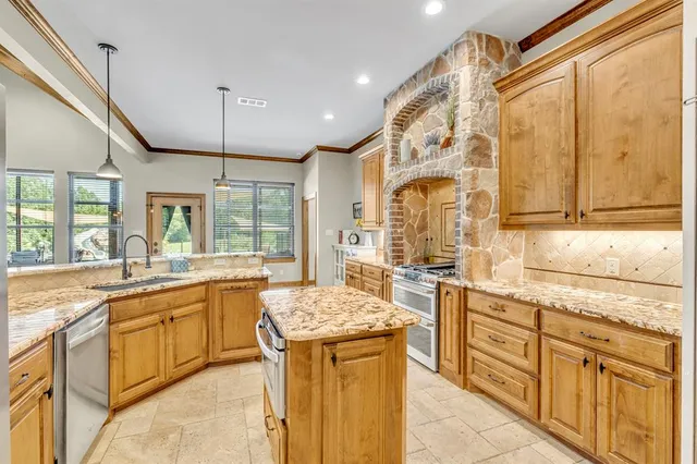 a kitchen with stainless steel appliances granite countertop a sink and cabinets