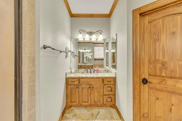 a bathroom with a granite countertop sink a mirror and a shower