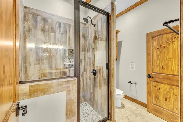 a bathroom with a glass shower door and a sink