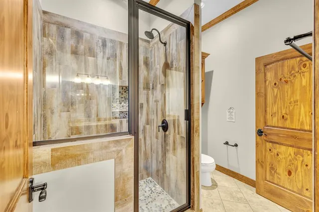 a bathroom with a glass shower door and a sink