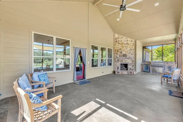 a living room with furniture and a floor to ceiling window