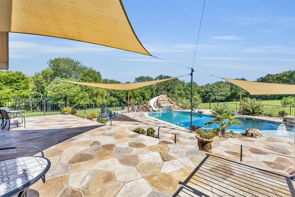 a view of a swimming pool with a patio