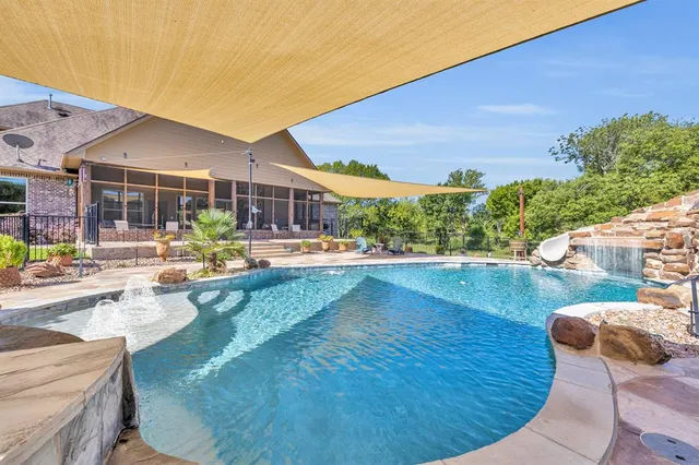 a view of a swimming pool with a patio