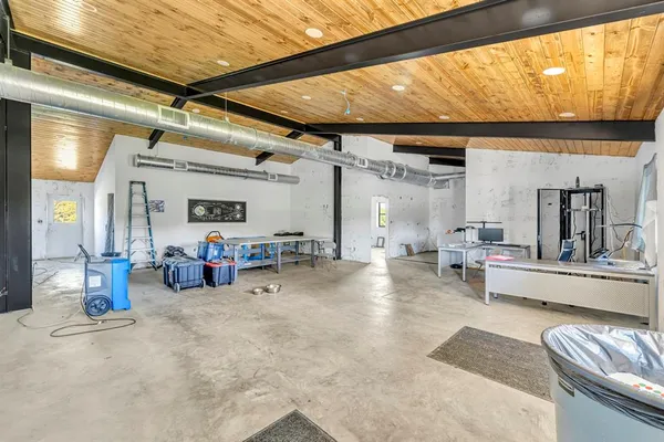 a view of a livingroom with furniture and a window