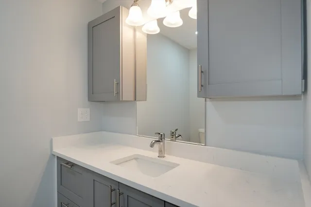a bathroom with a sink vanity and a mirror