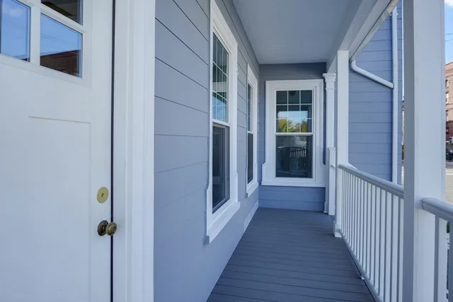a view of a hallway with wooden floor and entryway