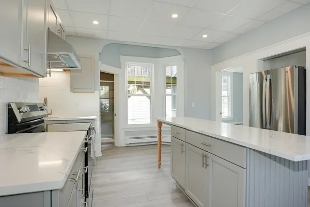 a kitchen with a sink appliances and cabinets