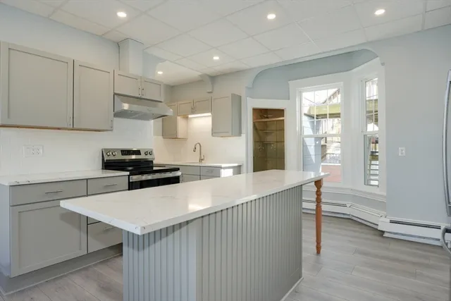 a kitchen with a sink a stove a refrigerator and cabinets