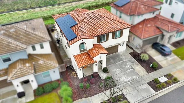 view of a kitchen with a refrigerator and white cabinets