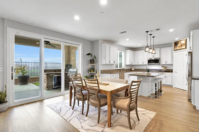 a kitchen with kitchen island granite countertop a sink center island and stainless steel appliances