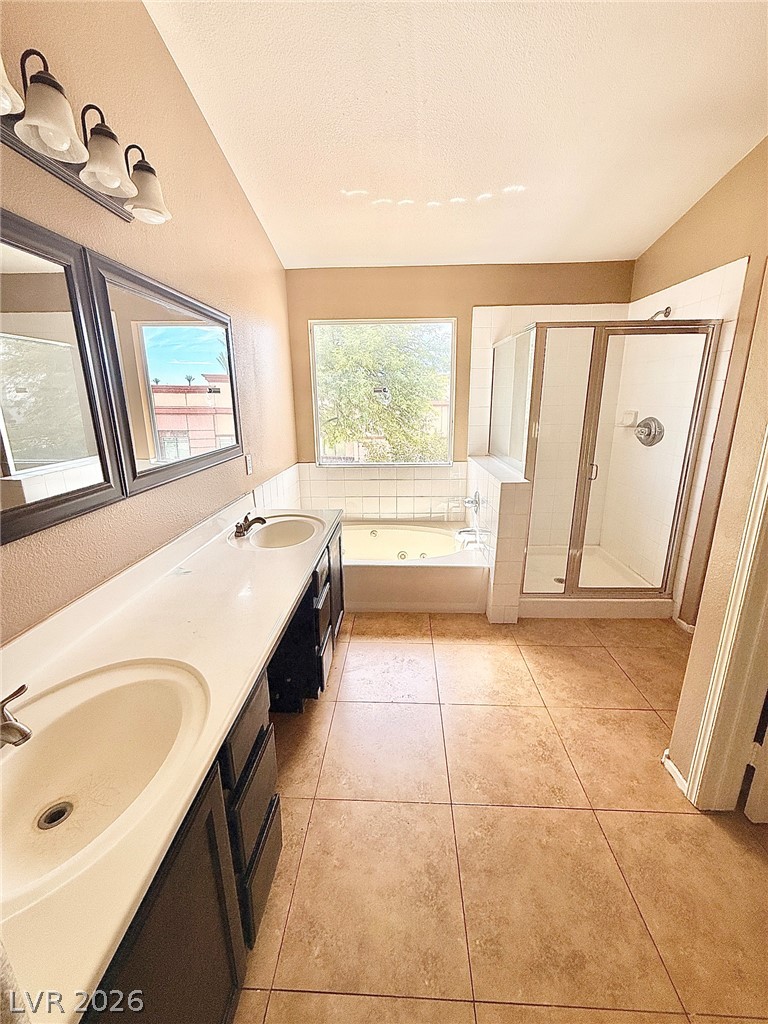 4313 Ranch Foreman Road North Las Vegas, NV 89032 - Photo 13 of 27 Tiled flooring and a double vanity complement the separate shower and tub setup.