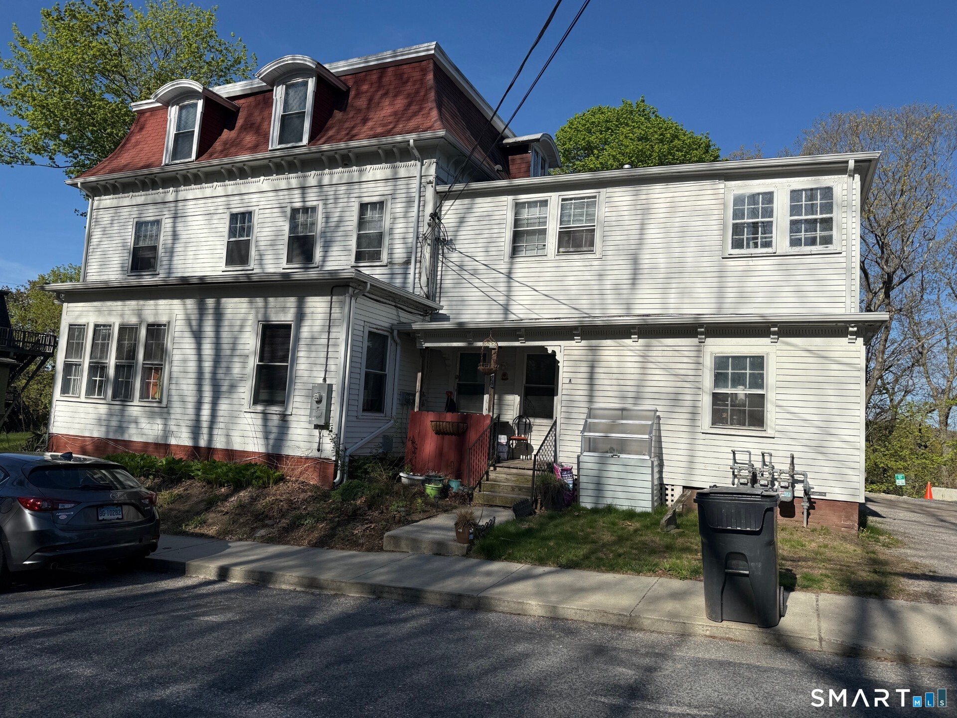 24 Wilkinson Street, Unit C Putnam, CT 06260 - Photo 1 of 1 a front view of a house with garden